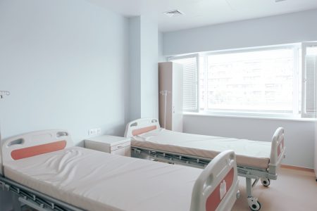 Hospital beds against the wall and other medical equipment in a hospital room